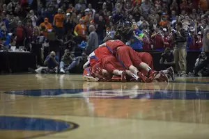 Dayton players pile on to one another after the Flyers upset Ohio State in the second round of the NCAA Tournament on Thursday.