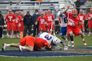 Duke faceoff specialist Brendan Fowler (right) wrestles for the ball at the faceoff X in the Blue Devils' 21-7 triumph over the Orange on Saturday. 