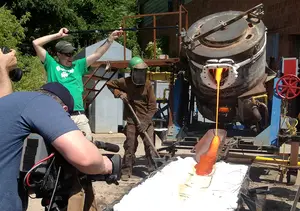 Students and faculty pour lava out of a machine. SU now offers an online course titled 