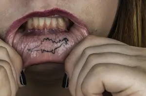 Jessica Reuveni’s dinosaur tattoo on her bottom lip was inspired by a sign at Occupy Wall Street. Her other tattoos are in memory of her sister, Gabby.        