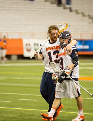 Syracuse reserve goalie Evan Malloy (left) consoles senior Billy Ward (right), as Ward's collegiate career comes to a premature end. 