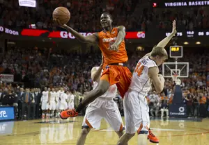 Tyler Roberson splits two Virginia defenders the last time Syracuse and Virginia squared off. The Cavaliers won that meeting 75-56. 