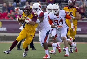 The Syracuse defense converges to bring down Central Michigan running back Devon Spalding during the Orange's 40-3 victory.