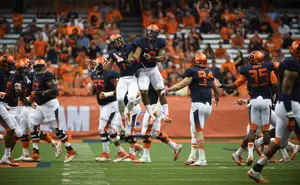 Julian Whigham (left) and Darius Kelly (right) celebrate in Syracuse's 28-6 loss to Louisville on Friday. Whigham and Kelly were part of a secondary that turned in a solid performance despite the defeat. 