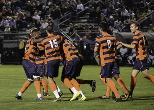 Syracuse celebrates a goal in its 4-0 win over Connecticut on Tuesday night. The Orange and Huskies were close in the first half before SU scored three goals in a 10-minute span at the start of the second. 