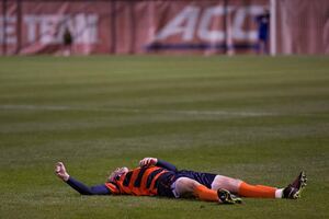 Liam Callahan lays on the ground during the first half of Syracuse's 3-1 win over Wake Forest at SU Soccer Stadium on Friday night. Callahan left with the help of trainers with a high ankle sprain and said after the game that he'll likely miss at least a week. 