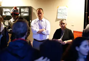 (From left) Gabe Nugent, associate general counsel for SU, and Bea Gonzalez, University College dean, speak with student protesters on Friday night. 