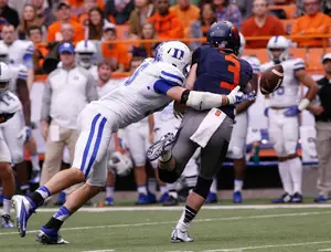 Syracuse quarterback Mitch Kimble is pressured and the ball squirts out in the Orange's 27-10 loss to No. 22 Duke on Saturday. 