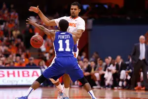 Michael Gbinije dribbles the ball at Deron Powers in Syracuse's 65-47 win against Hampton on Sunday in the Carrier Dome. Gbinije struggled as a point guard but excelled as a forward in the game.