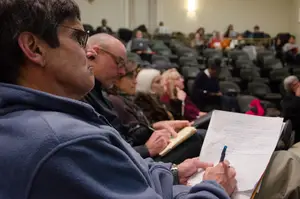 Terry McConnell, a professor on the Undergraduate Excellence Workgroup, takes notes during a forum held Monday night in Maxwell Auditorium. Members of the SU community were able to share concerns about SU with members of the workgroup.