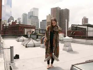Miranda Watson stands on the rooftop of her apartment in New York City. She wears a printed kimono jacket, which she designed herself. Watson considers her personal style as casual and comfortable.   