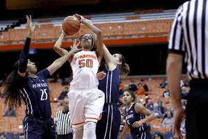 Syracuse sophomore Briana Day looks to attack the basket as Penn State forward Peyton Whitted defends.