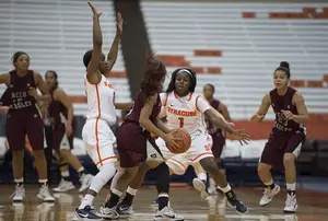 Syracuse guards Alexis Peterson (right) and Diamond Henderson (left) swarm a North Carolina Central ball-handler during SU's blowout win Sunday.
