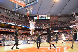 Syracuse forward Michael Gbinije glides to the basket for a second-half layup in the Orange's 85-67 defeat of Long Beach State on Sunday. The junior went for a career-high 24 points.