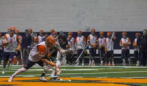 Ben Williams (37) of Syracuse battles Le Moyne during the face-off of a scrimmage on Jan. 24th 2015.