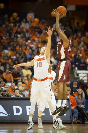 SU guard Trevor Cooney tightly contests a 3-point shot by Florida State's Xavier Rathan-Mayes in the first half of the Orange's win.