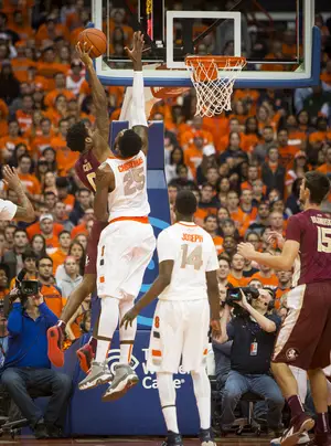 Syracuse senior Rakeem Christmas attempts to deny a Florida State player's drive to the rim during the Orange's win Sunday night.