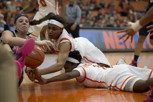 Cornelia Fondren and Alexis Peterson dive for a loose ball following a Fondren transition basket in the second half. Syracuse held Pittsburgh to just 13 points after the break. 