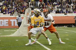 Syracuse defender Brandon Mullins, seen here marking Albany's Lyle Thompson last year, will likely receive his toughest assignment of the year Sunday in Duke midfielder Myles Jones.