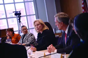 Sen. Kirsten Gillibrand and Rep. John Katko discuss a bill that aims to combat sexual assault on college campuses at a roundtable event at Syracuse University on Monday. They were joined by Mayor Stephanie Miner and other area leaders.