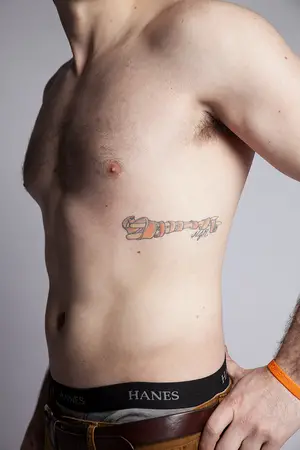 Dan Rosone honored his late best friend, Nicklaus Russo, with a tattoo on his ribcage. It features Russo’s initials and drumsticks wrapped in the orange Leukemia ribbon.   