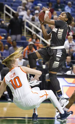 Wake Forest guard Amber Campbell is fouled on the way to the basket by Syracuse forward Isabella Slim in the first half of the second round of the ACC tournament on Thursday.