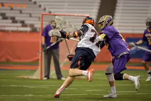 Henry Schoonmaker runs to the goal in Syracuse's 17-12 win over Albany. He accounted for five of those tallies on Thursday night. 