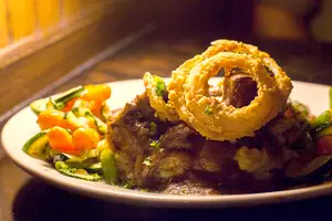 CopperTop Tavern’s Guiness braised short ribs were paired with delicious mashed potatoes, and topped with onion rings and stew-like gravy. The dish included a generous helping of steamed carrots, broccoli and green squash.                 