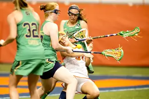 Syracuse attack Halle Majorana struggles to find space among a swarm of Notre Dame defenders. The Orange failed to convert on late-game opportunities in an overtime loss to the Fighting Irish.