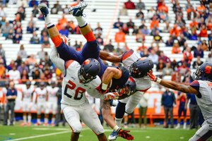 SU defensive back Antwan Cordy (28) upends tight end Trey Dunkelberger on Saturday afternoon after a catch.