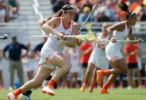 Kayla Treanor runs by a Penn defender. She scored four goals and had two assists in Syracuse's second-round win on Sunday.