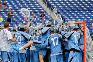 Johns Hopkins celebrates following the team's 16-15 victory over the second-seeded Orange in the quarterfinals of the NCAA tournament. 