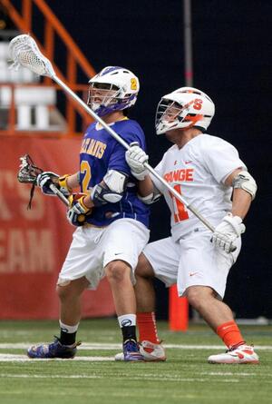 Former SU defender Brian Megill (right) was named to the United States roster on Wednesday. He may defend Miles Thompson (left) again when the U.S. faces the Iroquois Nationals on Sept. 18.