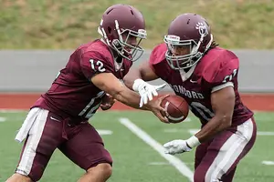 Calvinaugh Jones takes a handoff from quarterback Brian Novak. Jones has found stability at D-II Concord University and has dreams of playing in the NFL.