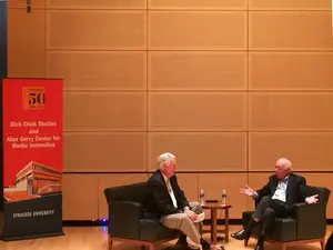 (From left) John Nicholson, the director of the Newhouse Sports Media Center, and Dick Stockton, legendary sports broadcaster, discuss Stockton's career and life advice in the Joyce Hergenhan Auditorium on Wednesday night.