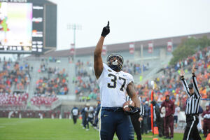 Pitt running back Qadree Ollison points skyward after scoring a touchdown.