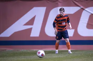 Andreas Jenssen looks downfield to move the ball away from Syracuse's midfield unit.
