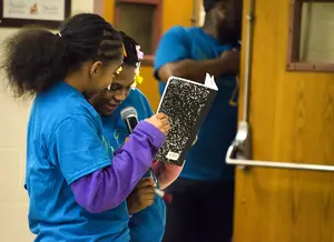 Two students in the Syracuse City School District recite a piece of writing they collaborated on during a class at the 2015 Writing Our Lives conference on Saturday. The annual event took place at Danforth Middle School.            