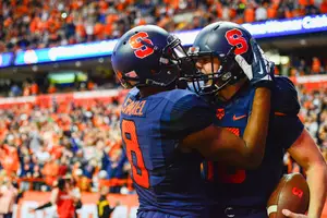 Steve Ishmael grabs the helmet of Zack Mahoney to celebrate a touchdown against No. 1 Clemson on Saturday.
