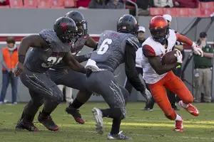 SU H-back Ervin Philips takes on several N.C. State defenders. He logged 27 rushing yards and 36 more receiving. 