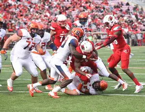 A host of Orange defenders tries to bring down a Louisville player with the ball. 