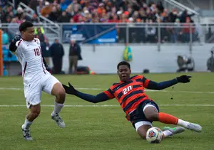 Freshman defender Kamal Miller slides for a ball in Syracuse's 1-0 win over Boston College on Saturday. SU's defense played a key role in its Elite Eight victory.