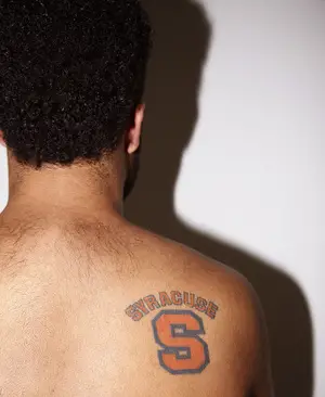 To prove his loyalty to the SU men's basketball team, despite the NCAA sanctions, Kenny Lacy decided to tattoo the SU logo on his shoulder.