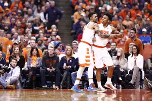 Malachi Richardson is held back by Michael Gbinije. Richardson got heated after getting tied up with Notre Dame's Matt Ryan.