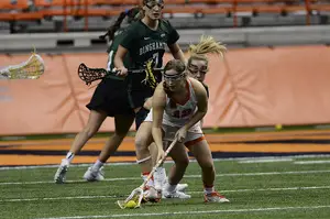 Nicole Levy (12) scoops up a ground ball on Sunday night against Binghamton. The Orange committed 16 turnovers in the 9-6 victory.