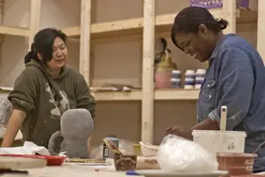 Eunjung Shin-Vargas and Tracy Delee, instructor and student, respectively, at a handbuilding class at the Community Folk Art Center. The center will be showing a new exhibit this weekend.