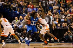 Tyler Roberson protects the paint against an MTSU player. The Orange's 2-3 zone packed in against the Blue Raiders and Syracuse kept its season alive.