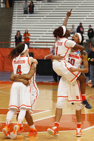 Maggie Morrison, Alexis Peterson (No. 1) and Briana Day (No. 50) celebrate fourth-seeded Syracuse's historic win over 12th-seeded Albany. 