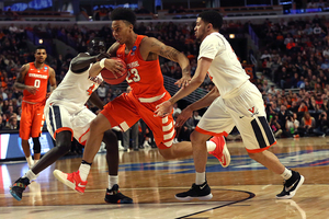 Malachi Richardson blows through two defenders during Syracuse's upset of No. 1-seeded Virginia on Sunday. SU's Final Four foe is No. 1 seed North Carolina at 8:49 p.m. on Saturday in NRG Stadium in Houston. 