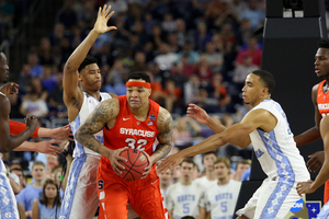 Dajuan Coleman looks to dish the ball off as he's swarmed by two North Carolina defenders in the Final Four on Saturday night.